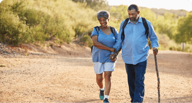 Older couple is walking through the nature together